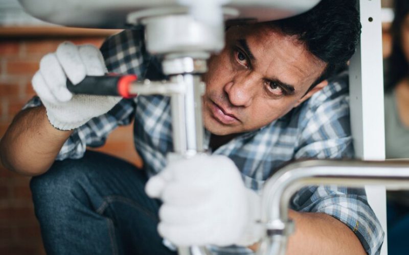 plumber-fixing-kitchen-sink_53876-82604